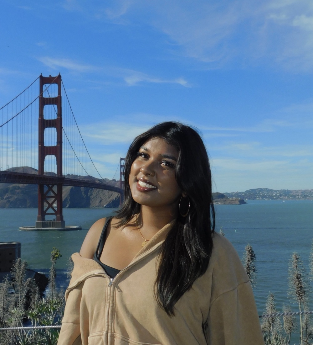 Jadiha smiling in front of the Golden Gate Bridge